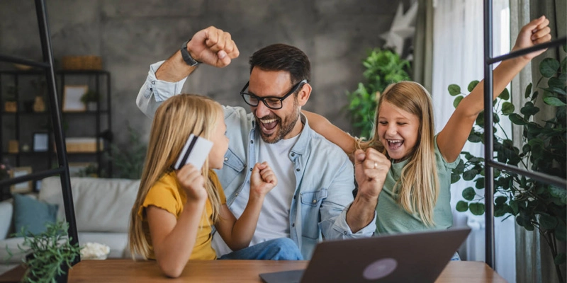 Father cheering with his daughters.